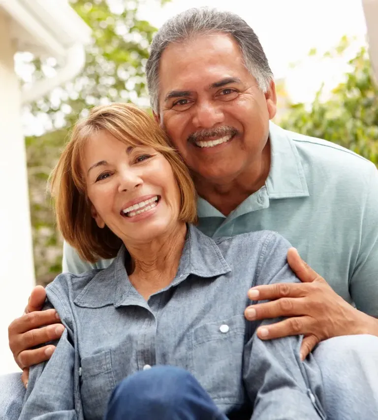 Senior couple walking hand in hand on a gravel path